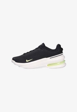 Scarpa da corsa Nike in bianco e nero con suola a cuscino d'aria verde chiaro e lacci neri, vista laterale su sfondo bianco.