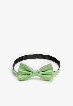 Lysegrøn butterfly med hvide polka dotter, lavet af tekstureret stof, featuring en solid sort justerbar rem til tilpasning.