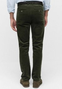 Oliwkowe spodnie z korduroyu o slim fit, z dwoma tylnymi kieszeniami i plecionym paskiem. Miękka tekstura z widocznymi wzorami korduroyu.