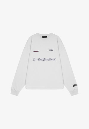 Fehér, hosszúujjú pulóver pamutból, lila és szürke nyomtatott logókkal, bordás mandzsettákkal és szegéllyel. Egyszerű, dobozszerű fazon.