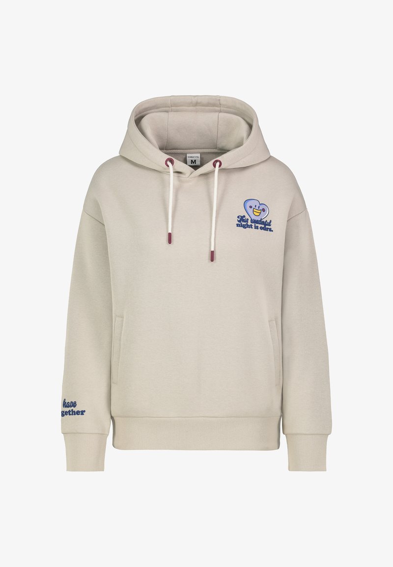 Beige hoodie made of soft fabric, featuring a front pocket, drawstring hood, blue graphic with smiley face, and text accents on sleeves.