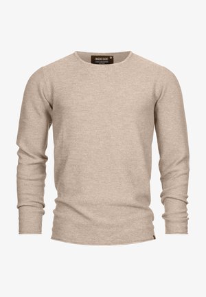 Jersey de manga larga beige hecho de una tela de punto texturizada. Presenta un escote redondo y una pequeña etiqueta de la marca en el dobladillo.