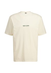 T-shirt en coton crème avec des manches courtes et un col rond. Il arbore un logo imprimé "NEW YORK WORLDWIDE" en vert foncé au centre.