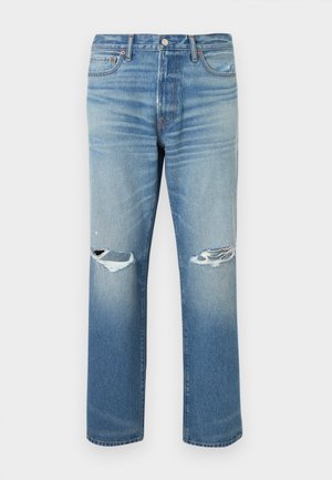 Lys blå denimjeans med avslappet passform, med slitne revner ved knærne og rette ben. Klassisk femlommersdesign.