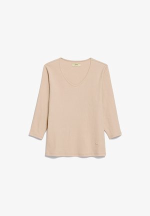 Beżowy, długi rękaw, dzianinowy top z dekoltem w serek i małą metką logo blisko dolnego brzegu, leżący płasko na białym tle.