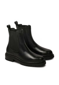 Black leather Chelsea boots featuring elastic side panels, round toes, and textured rubber soles. Pull tabs on the back for ease of wear.