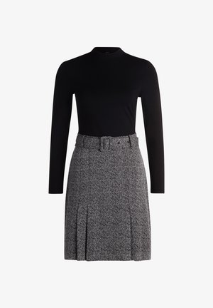 Black long-sleeve top paired with a patterned gray skirt featuring a belt, pleats, and a textured design.