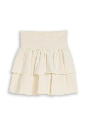 Cream-colored, tiered, ruffled mini skirt with a wide, high waistband and a flowy, layered design.