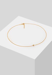 Collier en or avec une chaîne délicate, présentant un accent en perle ronde lisse et un fermoir sécurisant. Design épuré avec une chaîne d'ajustement flexible.