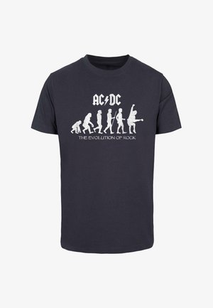 Sötétszürke pamut póló, amelyen az emberi evolúciót ábrázoló grafika, zenei figurák, valamint a "AC/DC" és a "ROCK EVOLÚCIÓJA" felirat fehér színben található.