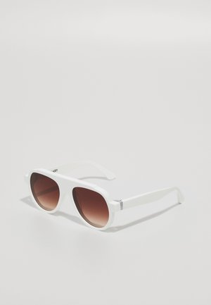 Sunglasses with a white plastic frame and brown gradient lenses. Features wide lenses and straight, sleek temple arms with subtle detailing.