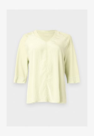 Light yellow V-neck shirt with three-quarter sleeves and visible seam details on front and sleeves.