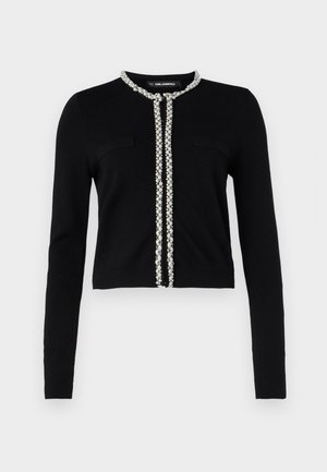 Cárdigan negro corto con mangas largas, que presenta una decoración de strass de imitación a perlas a lo largo del frente y dos bolsillos en el pecho.