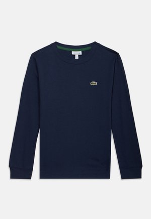Marineblaues Langarmshirt mit Rundhalsausschnitt, grünem Krokodil-Logo auf der linken Brust und gerippten Bündchen.