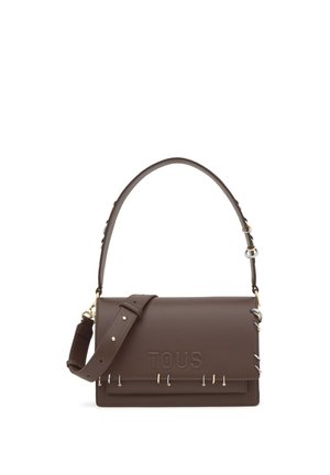 Bolso de hombro de cuero marrón con correa ajustable, logo "TOUS" en relieve y adornos de anillos metálicos a lo largo del borde de la solapa.