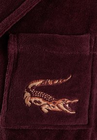 Burgundy terry cloth robe featuring a detailed embroidered crocodile on the pocket, with a soft texture and a classic design.