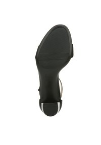 Zwarte hoge hak schoenzool met een textuur van rubber, ronde vorm en een geaccentueerde glanzende hak. Merklogo aanwezig op de zool.