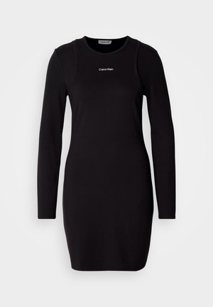 Rochie neagră cu mâneci lungi din țesătură netedă, cu decolteu rotund și logo subtil Calvin Klein pe piept. Croială mulată.