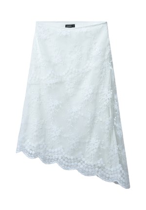 Gonna bianca in pizzo con motivi floreali e orlo a scallop. Il materiale è leggero e semitrasparente, con vita aderente.