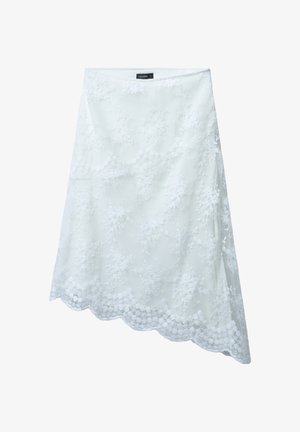 Gonna bianca in pizzo con motivi floreali e orlo a scallop. Il materiale è leggero e semitrasparente, con vita aderente.