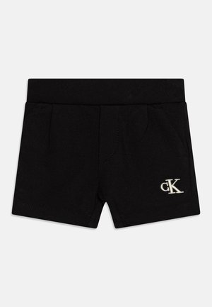 Pantalones cortos negros de algodón con bolsillos laterales, cintura elástica y un pequeño logo bordado en blanco en la parte delantera.