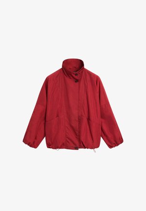 Loose-fitting red jacket with high collar, front buttons, elastic cuffs, side pockets, and adjustable drawstring hem.