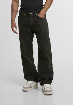 Black denim wide-leg jeans with a faded finish, featuring five pockets, a button closure, and a branded patch on the back waistband.