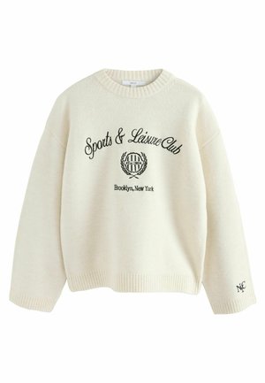 Pull en couleur crème en tissu doux avec un col rond. Comprend un texte brodé noir : "Club de Sport et de Loisirs" et un logo. Poignets côtelés.