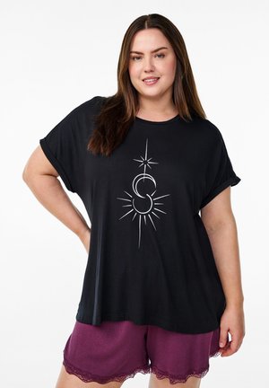 Black shirt with short sleeves features a white graphic design of a celestial symbol. Paired with burgundy shorts with lace trim.