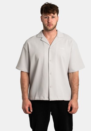 Light gray short-sleeve shirt with vertical ribbed texture, featuring a button front and collar, and small white logo on the chest.