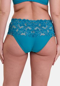 Bajo de color verde azulado con una cinturilla de encaje que presenta patrones florales. El material es una tela suave y elástica con un diseño ajustado y de corte alto.