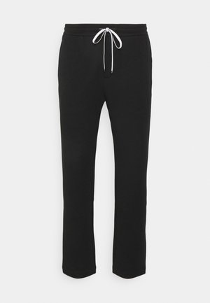 Pantaloni della tuta neri con un design a gamba dritta, cintura elastica e lacci bianchi regolabili. Tessuto morbido con una superficie liscia.