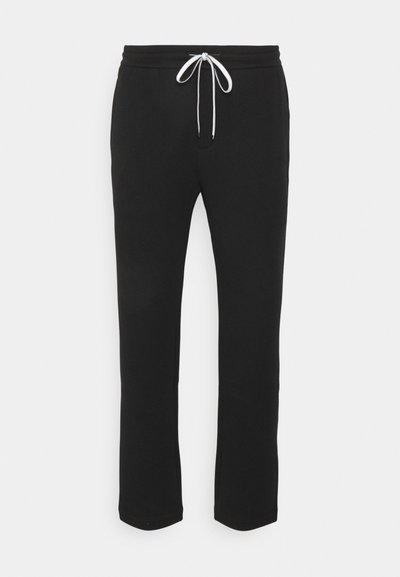 Pantaloni della tuta neri con un design a gamba dritta, cintura elastica e lacci bianchi regolabili. Tessuto morbido con una superficie liscia.