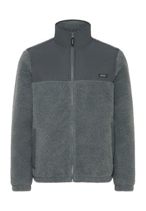 Veste en polaire de couleur gris foncé avec une partie supérieure lisse, zip complet, col haut et poignets élastiques. Présente un matériau texturé et chaud.