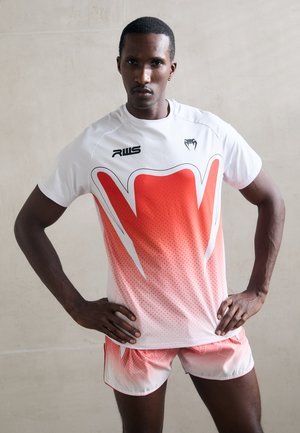 White athletic shirt with a red gradient design featuring geometric patterns. Matching red-accented shorts, casual fit.