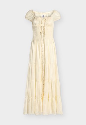 Krēmkrāsas, potītes garuma, kārtaina kleita ar īsām pūstām piedurknēm, savilktu korsetes daļu, priekšpusē pogām un nelielu aukliņu pie kakla izgriezuma.