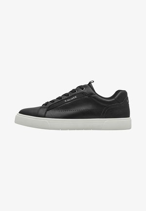 Black leather sneaker with a smooth texture, rounded toe, white rubber sole, and perforated details along the side. Brand name is visible.