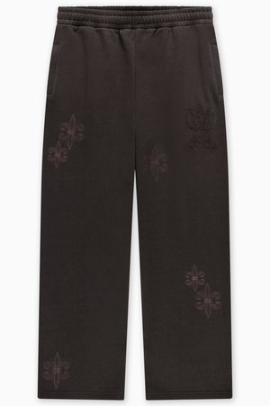 Pantaloni della tuta neri con fascia elastica in vita, tasche laterali e ricami floreali con fili chiari sulle gambe. Tessuto liscio.