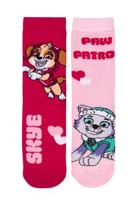 Calzini colorati con personaggi di cani dei cartoni animati. Il calzino sinistro è rosa con "SKYE" e cuori; il calzino destro è rosa chiaro con "PAW PATROL" e un cane.