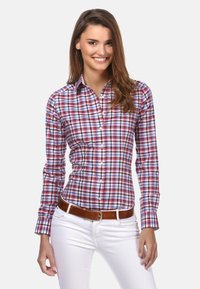 Button-up shirt with a multicolored plaid pattern in red, blue, and white. Long sleeves, pointed collar, and fitted design.