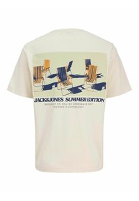 Cream-colored cotton t-shirt featuring a printed design of outdoor chairs in various colors and shadows, with text "JACK&JONES SUMMER EDITION."