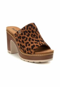 Sandalia deslizante de cuero con patrón de leopardo, parte superior de ante marrón, punta abierta y tacón alto apilado. Cuenta con una suela de goma y herrajes de acento.
