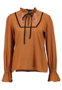 Rust-orange Bluse mit Rüschensaum, schwarzem Besatz und floralem Stickerei. Lange Ärmel mit ausladenden Manschetten, weiche Stofftextur.