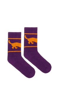 Fioletowe skarpetki z pomarańczowym wzorem dinozaura i poziomymi paskami. Wykonane z miękkiego materiału dzianinowego z prążkowanymi mankietami.