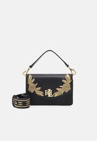 Black leather handbag with golden floral embroidery and a gold-accented logo. Features a top handle and a removable embroidered strap.
