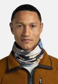 Multicolored neck gaiter featuring abstract patterns in blue, beige, and black, made of soft fabric, worn over a brown fleece jacket.