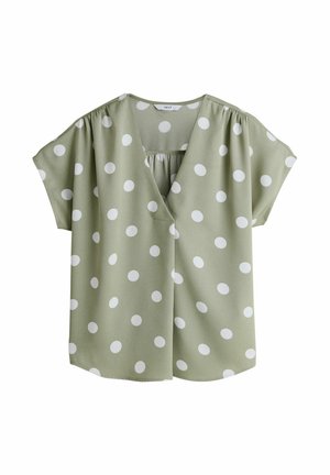 Zaļa blūze ar baltām punktiņām, V-veida izgriezumu, īsām piedurknēm un savākumu detaļu aizmugurē. Izgatavota no viegla auduma.
