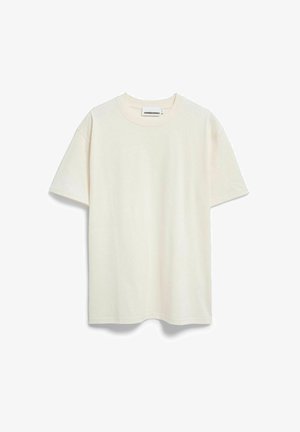 T-shirt couleur crème en coton doux, présentant un col rond classique, des manches courtes et une coupe décontractée, sans motifs ni accents visibles.