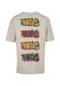 Krémové tričko s krátkými rukávy, zdobené vrstvovým textem ve stylu graffiti "DINGERS" v odvážných barvách, s nápisem "DANGEROUS" pod každým designem.