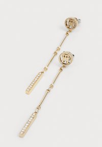 Gold-tone drop earrings featuring circular studs with a logo and elongated链 with a rectangular accent set with clear rhinestones.